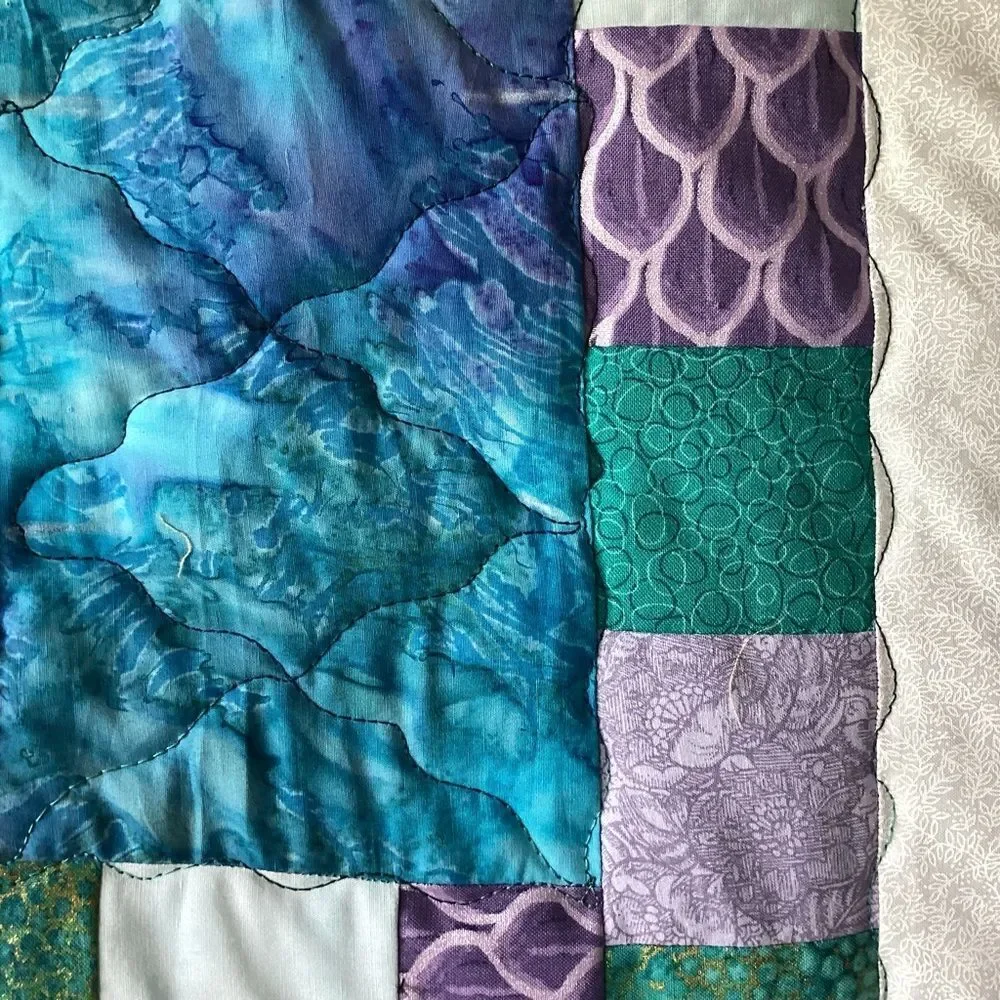 NWT. Hand Crafted Quilt of Blues, Purples and Turquoises